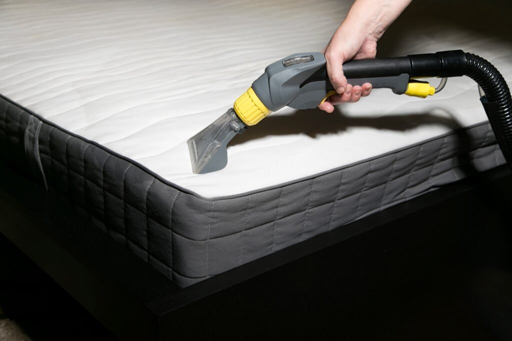 cleaning the mattress with a vacuum cleaner
