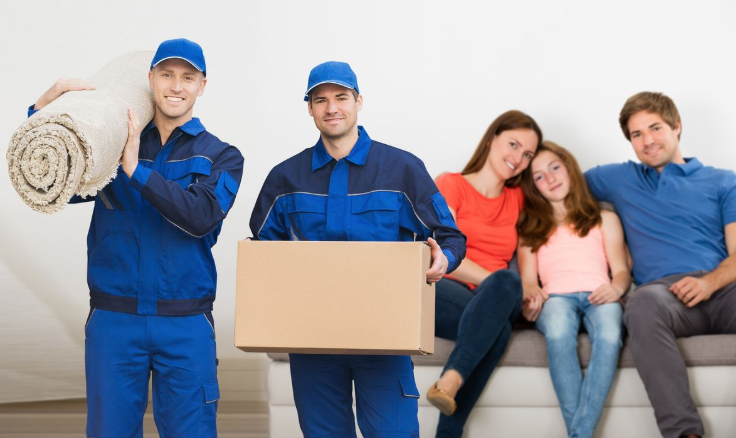 Professional cleaning technicians holding rug with happy family sitting on sofa
