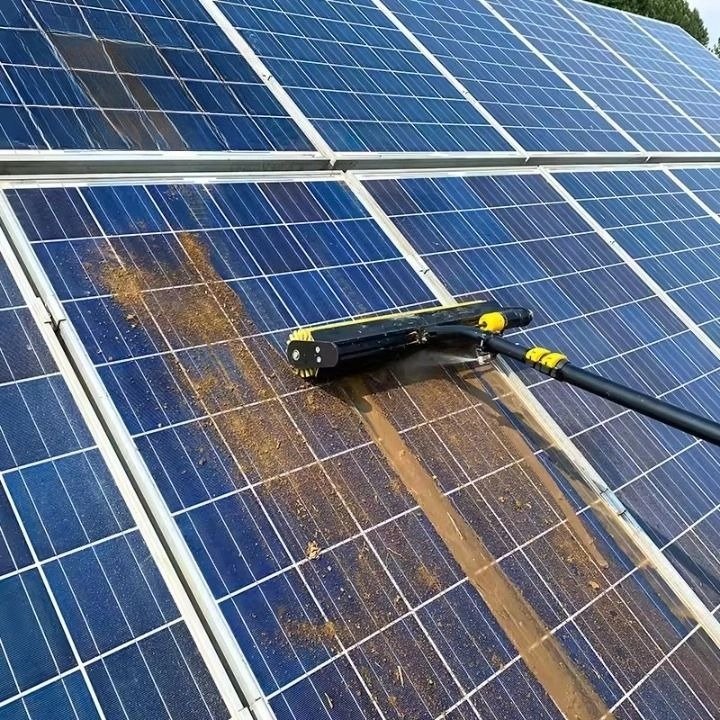 Solar panel cleaning Melbourne technician using water fed brush on rooftop solar panels