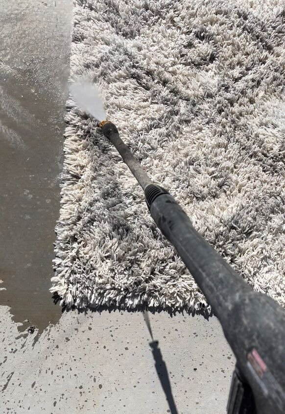 Pressure washing shaggy rug during professional rug cleaning service