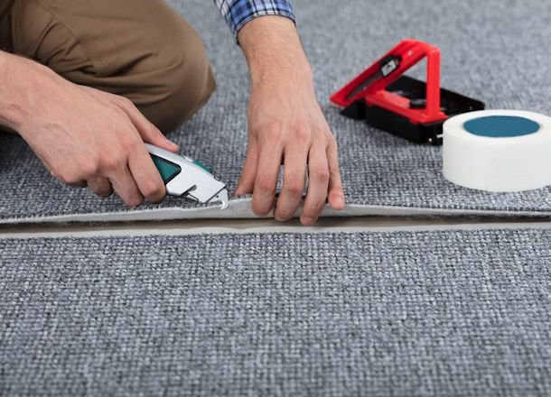 Professional technician performing Carpet Re Stretching Melbourne using specialised carpet stretching tools to tighten loose carpet and restore a smooth, wrinkle-free finish.