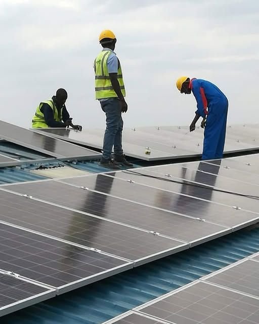 Professional technicians inspecting and cleaning rooftop solar panels to improve energy efficiency, remove contaminants, and maintain long-term solar system performance.